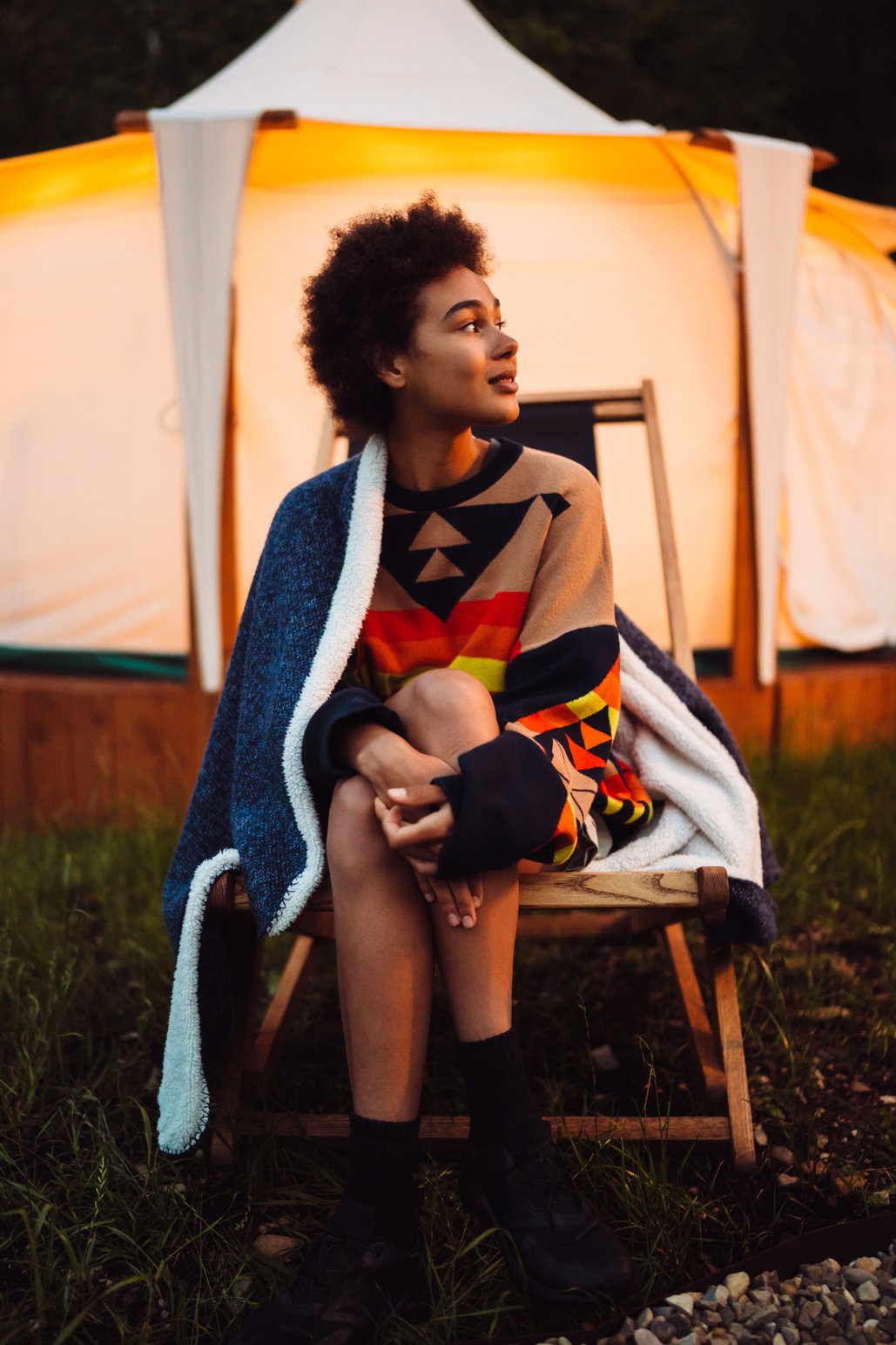 Young African Woman Sitting on Chair near Glamping Tent